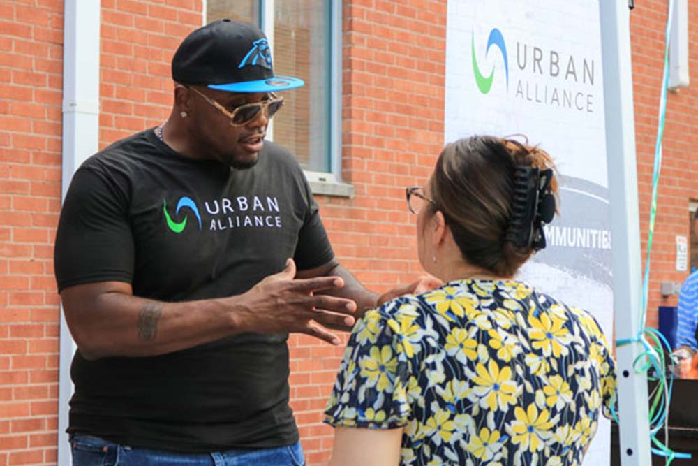 UA volunteers talk together outside of Urban Alliance's building.