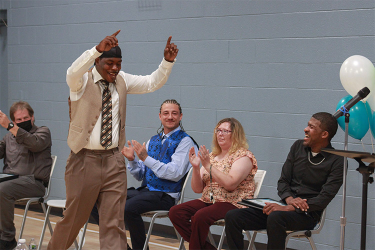 Change of Status graduate celebrates his achievements.