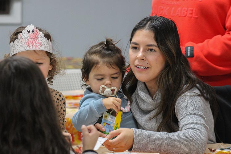 A young family participates in a holiday event.